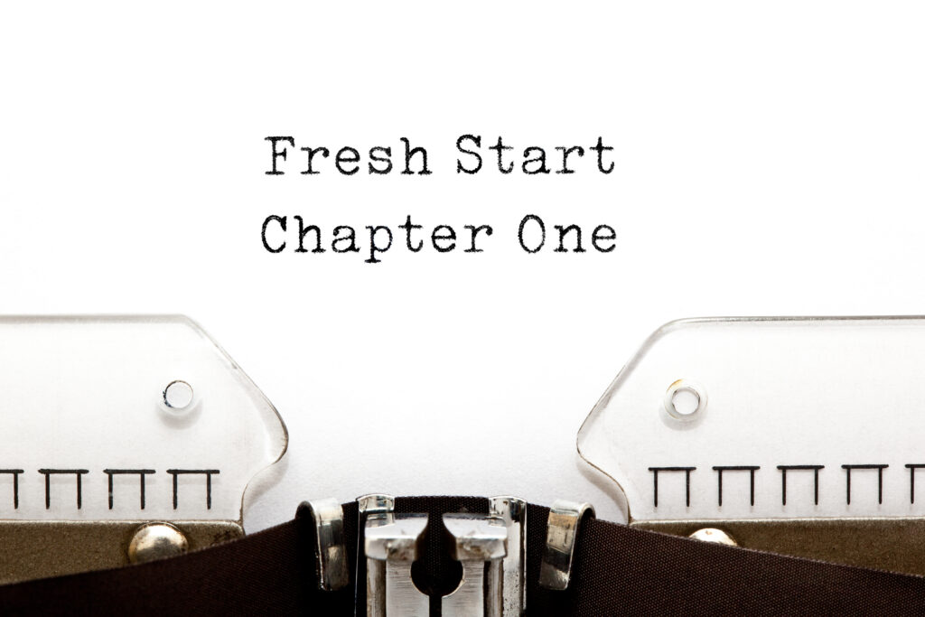 black and white typewriter with the words fresh start chapter one 
