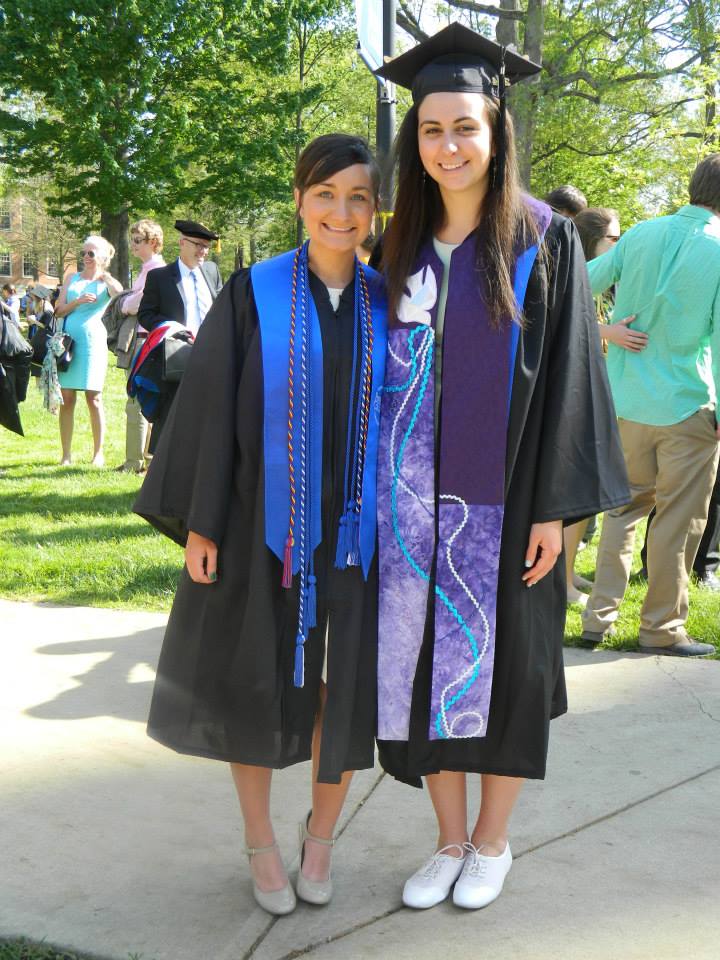 college graduation of Brit Suits founder of choose where to live on her way to find her best place to live. She is wearing a graduation cap and her friend is also in graduation garb.
