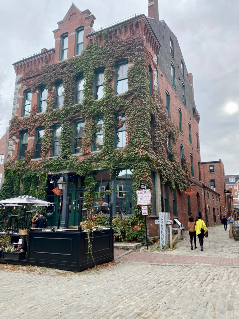 The Northe End in Boston. The brick  building is covered in ivy. It could be Brit Suits, founder of choosewheretolive.com's perfect place to call home. 